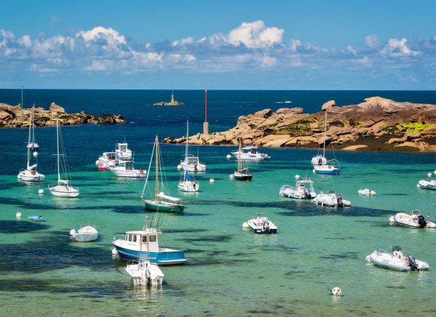 Boats and transparent water on Coz-Pors beach in Tregastel, Côtes d’Armor, Brittany, France Boats and transparent water on Coz-Pors beach in Tregastel, Côtes d'Armor, Brittany, France